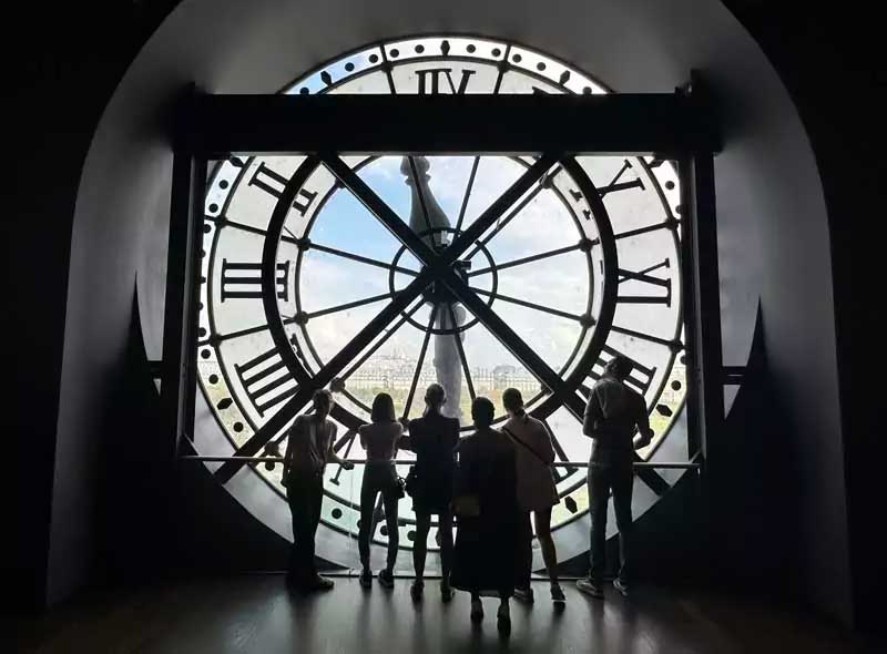 View of the large clock inside the Musée d’Orsay in Paris with a view of the Sacré-Coeur.