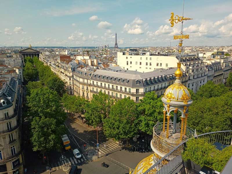 View of Paris rooftops from above showing the city’s iconic gray zinc roofs